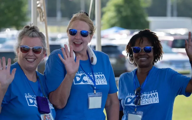 Desoto County Dream Center outreach volunteers waving hello.